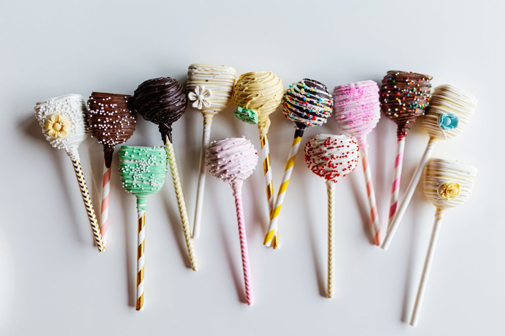 Decorated cake pops in a row