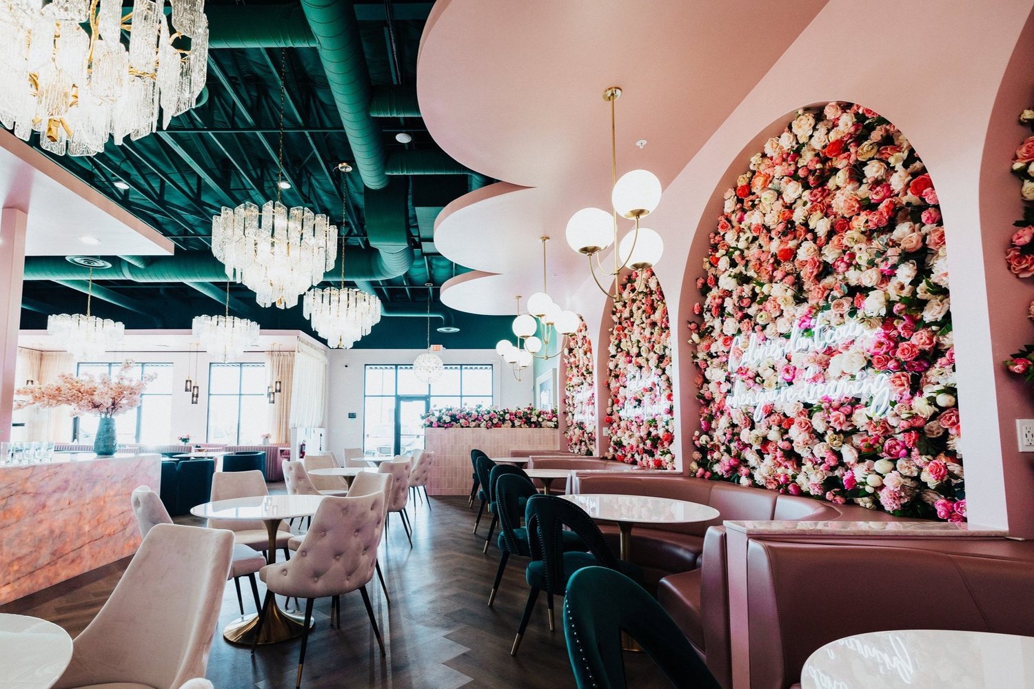 The dining room with flower-wall arches and chandeliers